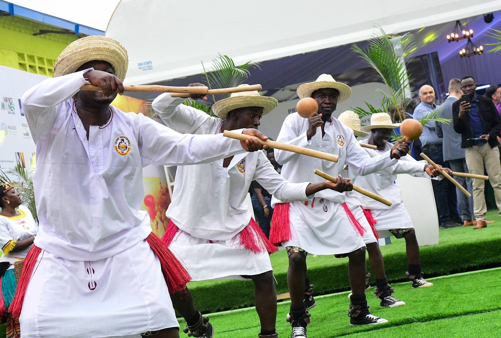 Traditional dancers performing in colorful attire at a cultural event in Uganda